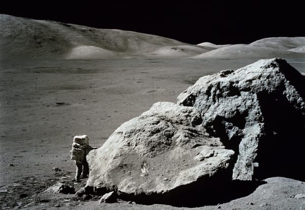 Photo of Apollo 17 geologist and astronaut Harrison Schmitt next to a large boulder at the Taurus-Littrow landing site. Source: NASA